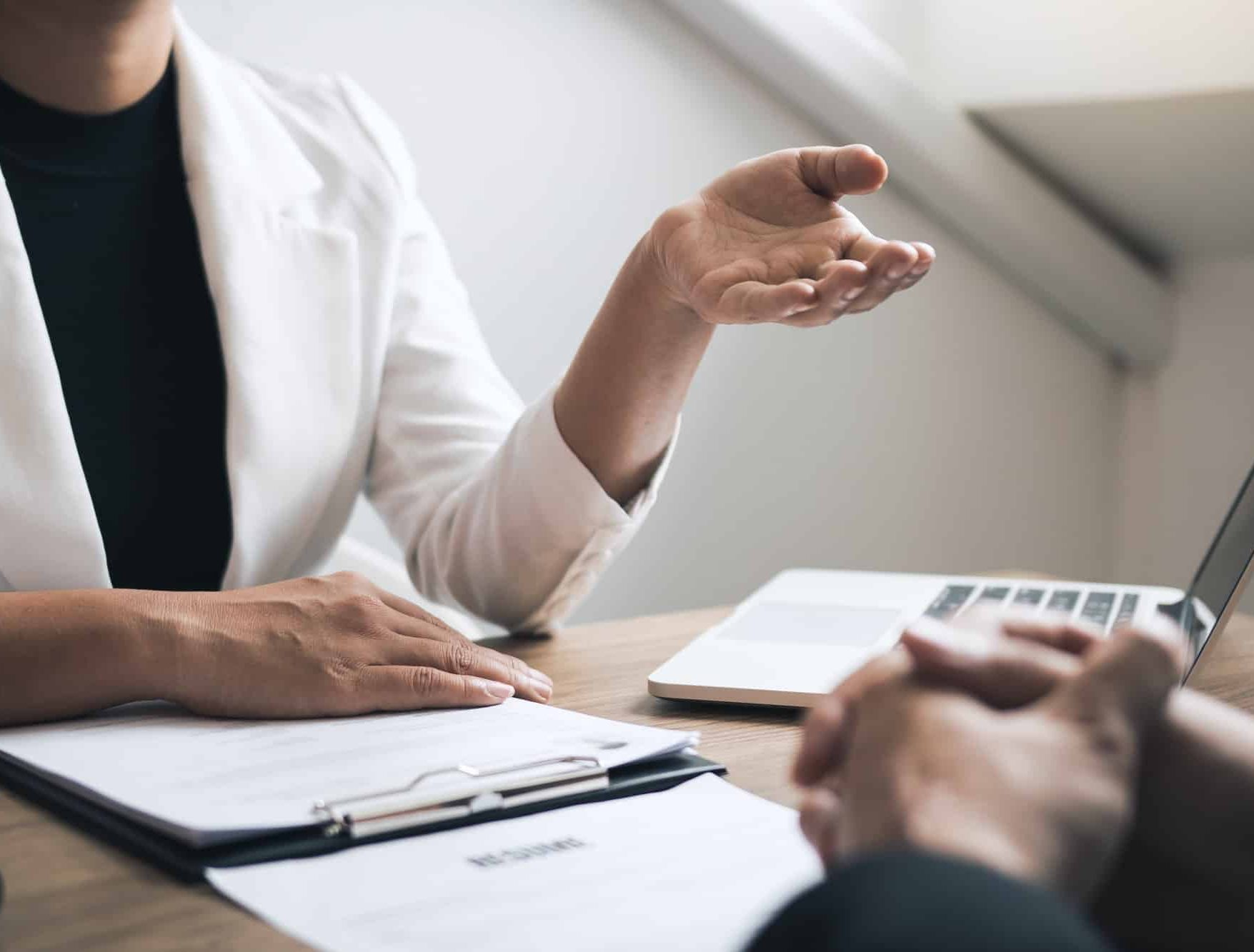Female managers are talking about the recruitment of staff at the office.
